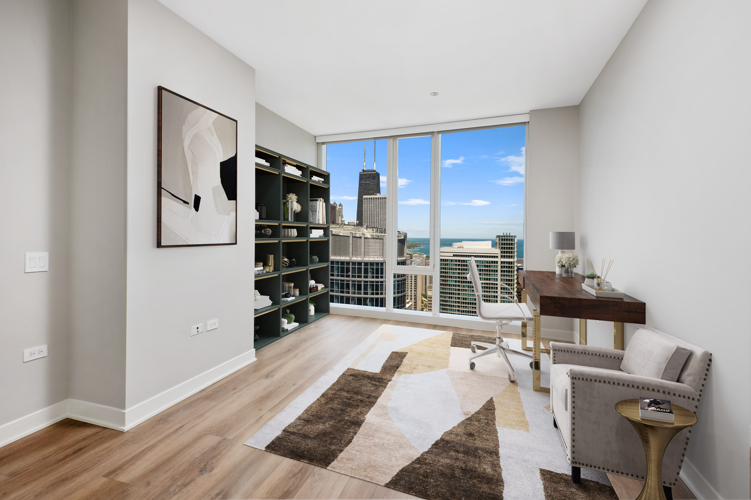North Water Apartments bright and airy home office with seating area and floor to ceiling windows overlooking the city and lake